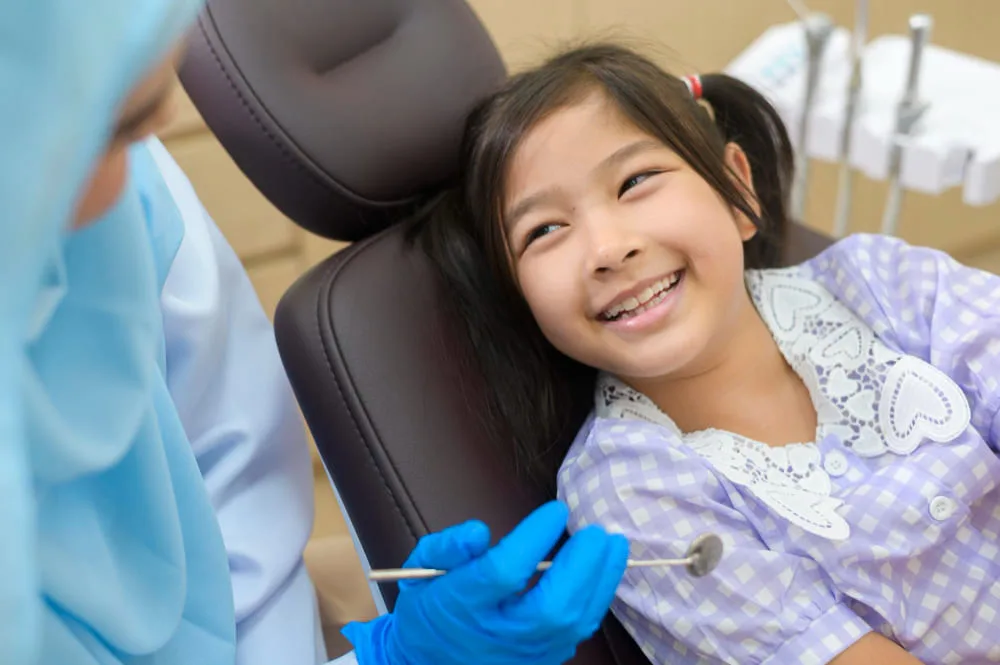 Dentist performing fluoride treatment procedure