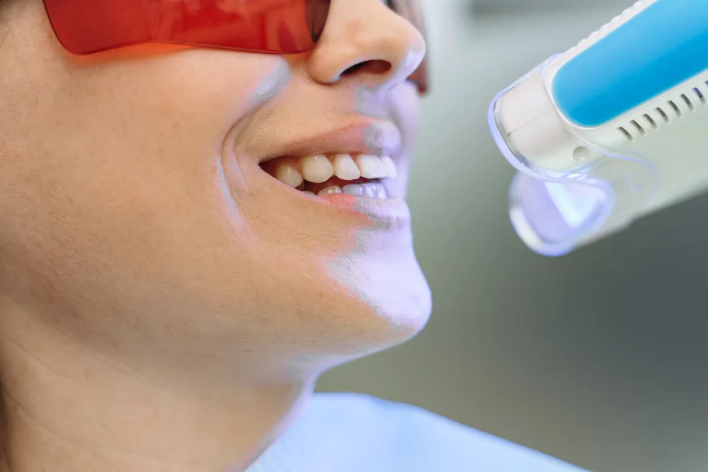 Dentist performing laser-assisted gum treatment procedure