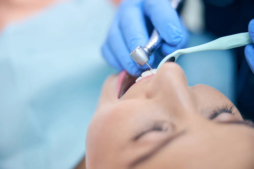 Dentist performing dental sealants procedure