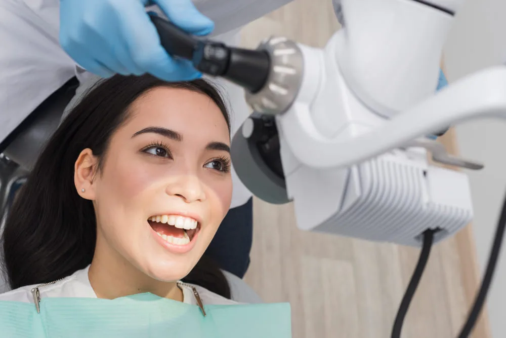 Dentist performing teeth whitening procedure
