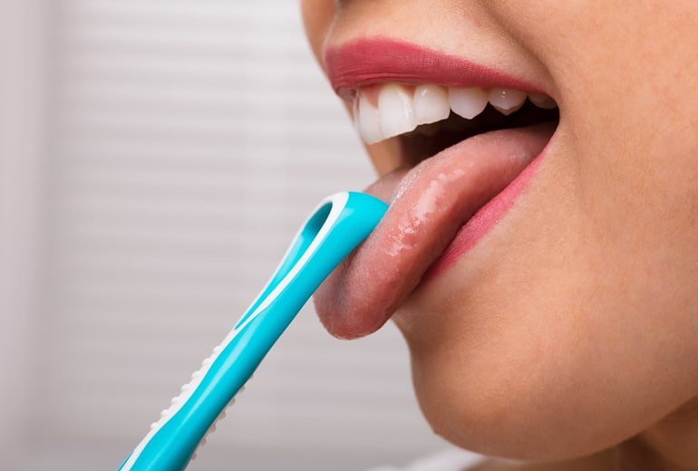 CLEANING BEYOND YOUR TEETH : THE SURPRISING BENEFITS OF TONGUE SCRAPING