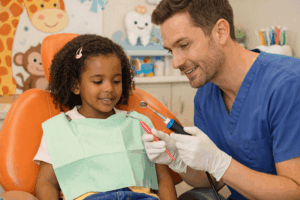 Dentist explains tools to young patient
