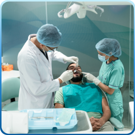 Two dentist giving Restorative Dentistry Treatment to a man